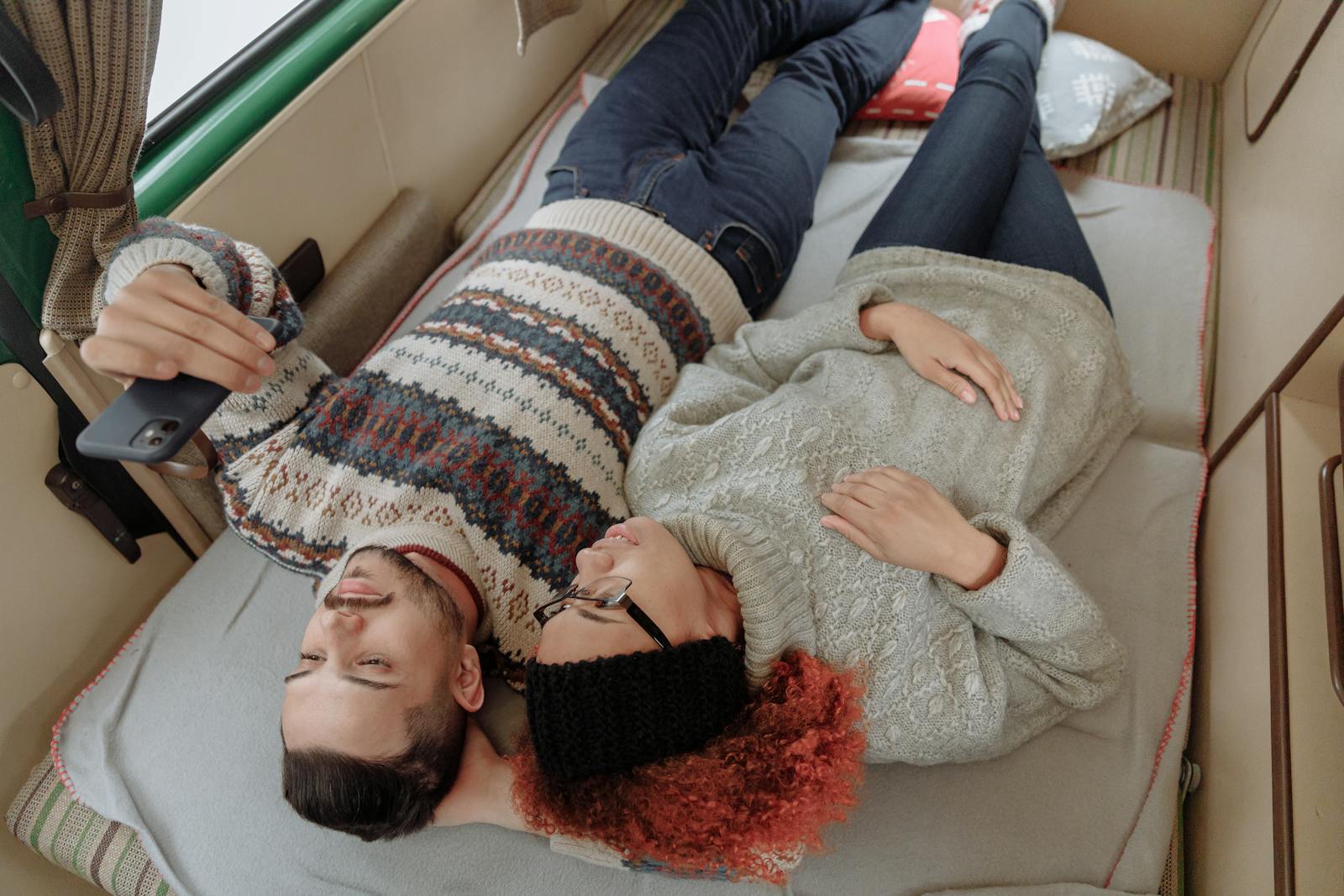 A Man and a Woman Lying in a Campervan